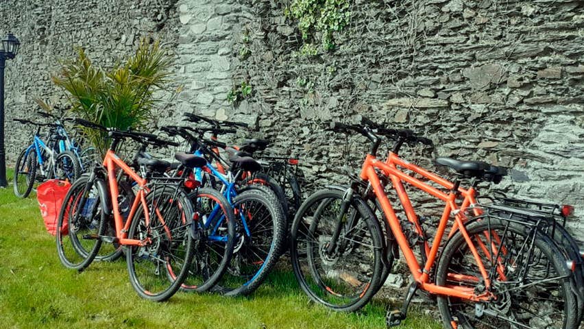 Bikes left up against a stone wall