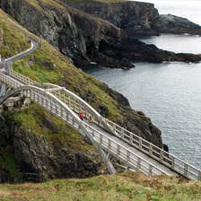 People walking across the bridge at Mizen Head in County Cork.