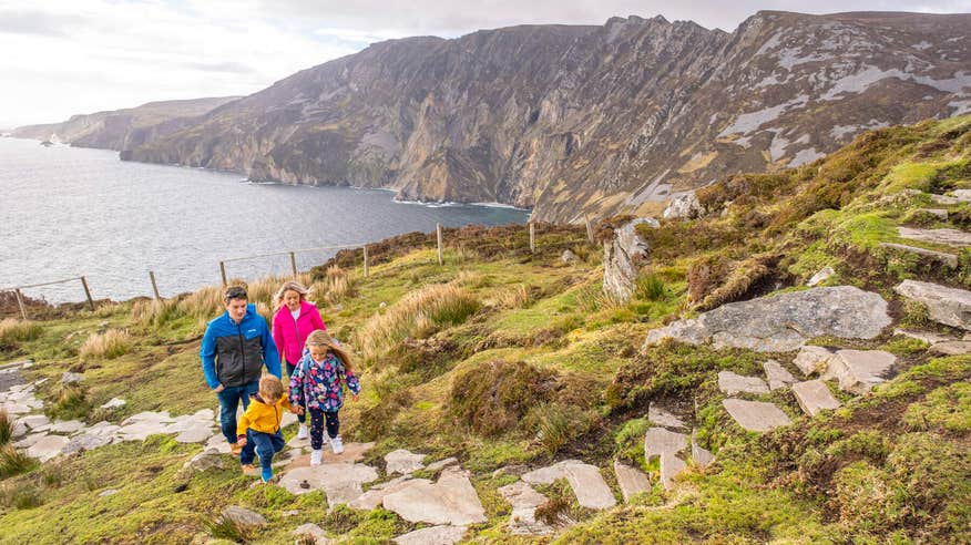 A family hiking up Sliabh Liag (Slieve League) in County Donegal